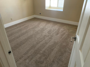 A freshly installed brown carpet in a residential room, demonstrating quality carpet work by Canyon State Flooring in Queen Creek, AZ.