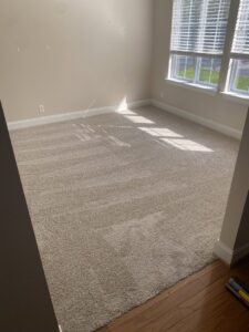 Freshly installed beige carpet in a bright bedroom by Legacy Flooring Co. in Murfreesboro, TN.