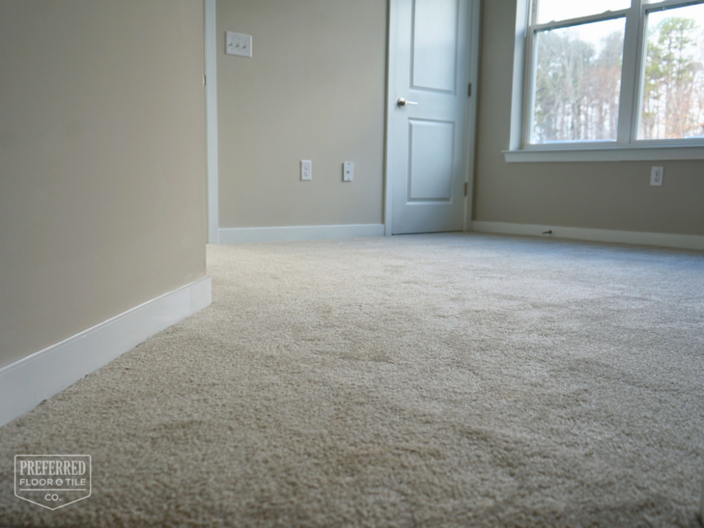 Freshly installed beige carpet in a bedroom by Preferred Floor & Tile CO. in Charlotte, NC