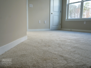 Freshly installed beige carpet in a bedroom by Preferred Floor & Tile CO. in Charlotte, NC