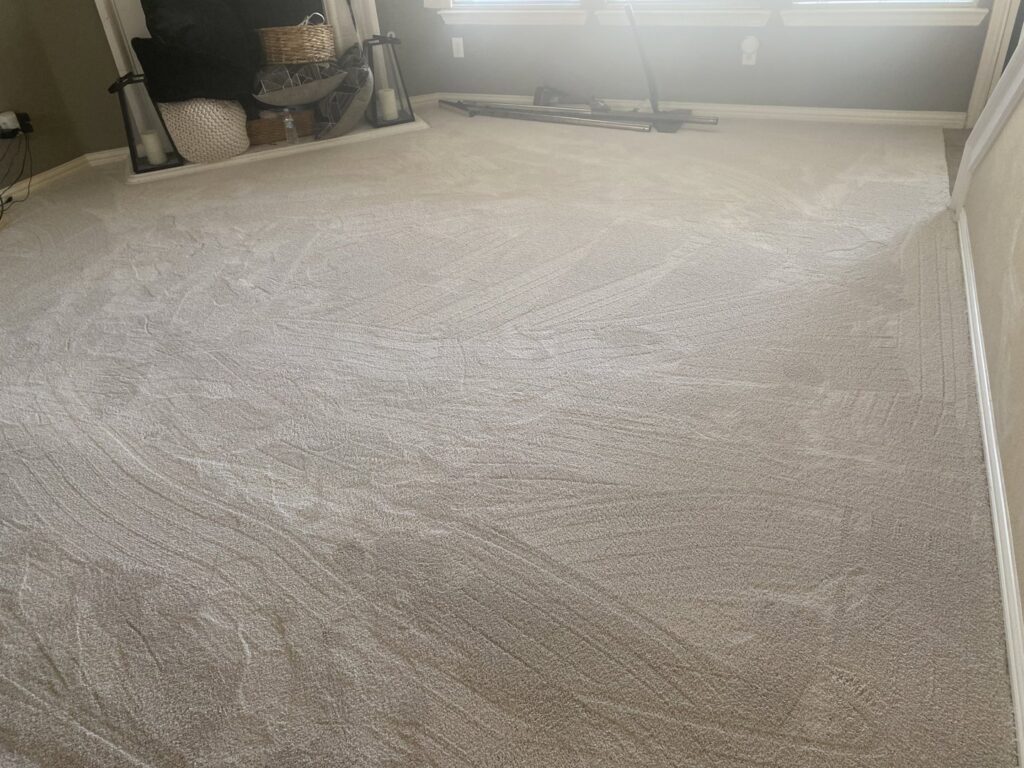 A bedroom with freshly installed light-colored carpet by Trendsetters Flooring in Benbrook, TX