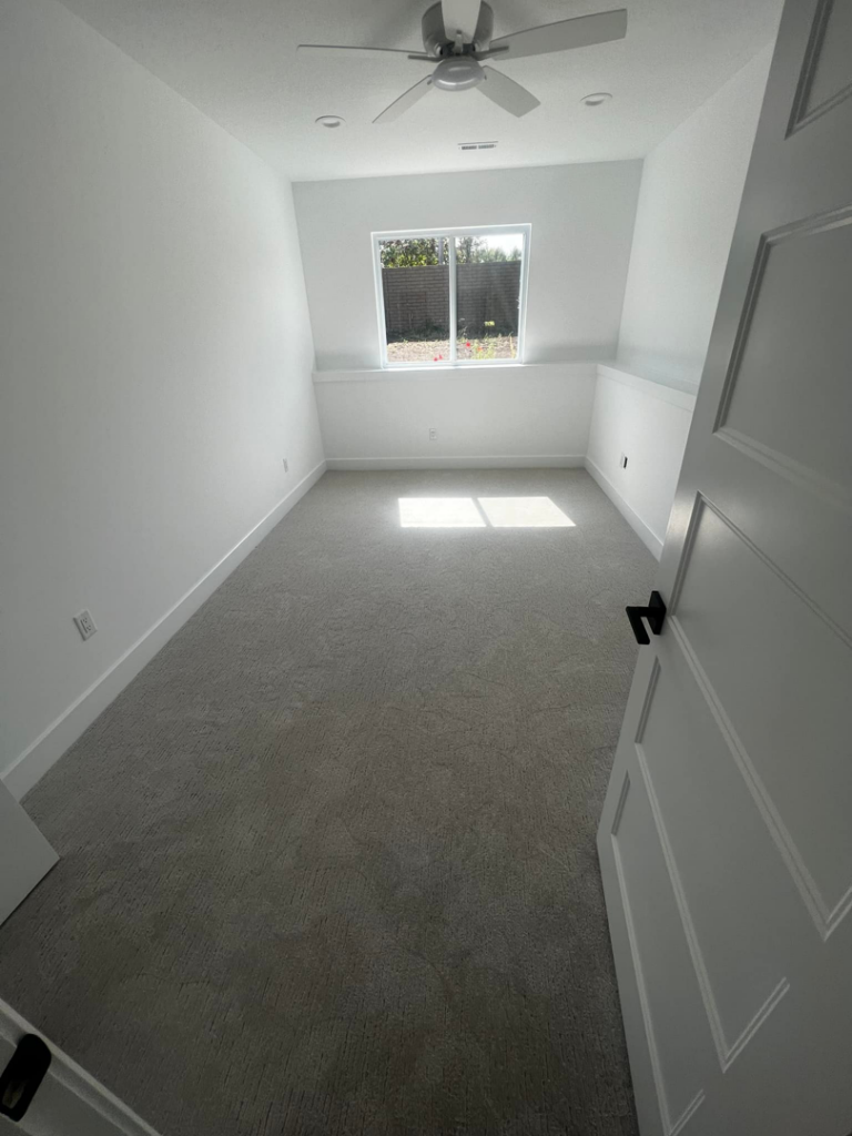 Freshly installed light grey carpet in an empty room by J3 Designs LLC in Wichita, KS