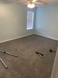 A freshly installed gray carpet in a bedroom, demonstrating quality work by Lestage Construction Carpet & Flooring in Atlanta, GA.