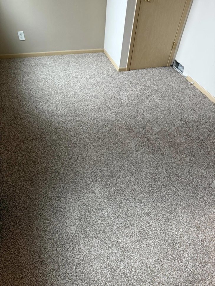 Freshly installed grey carpet in a bedroom by La 23 floors an more in Janesville, WI.