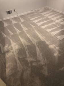 A room featuring freshly installed grey carpet with visible patterns, a quality carpet contractor job by Judkins Carpet & Floor Covering in Aurora, CO.
