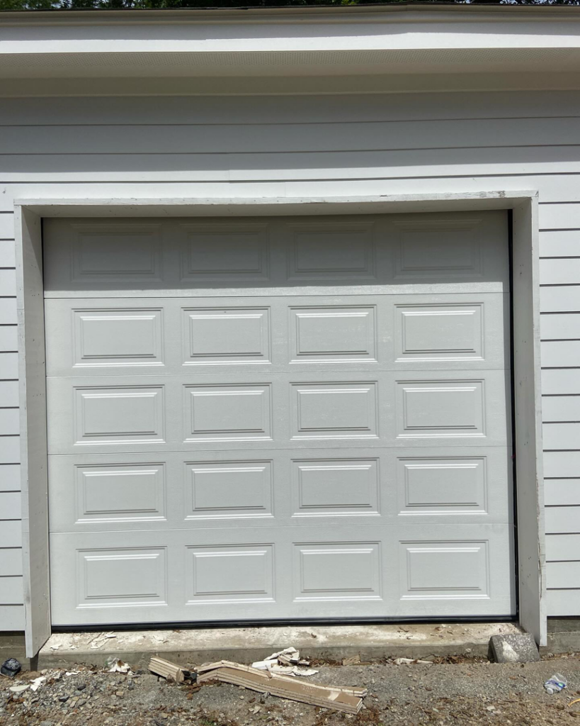 A freshly installed white garage door, showcasing quality work by J&C Bravo LLC for homes in Cordova, TN.