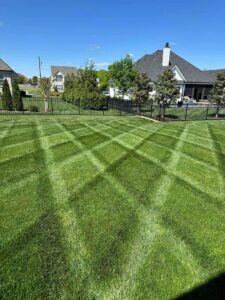 A perfectly mowed lawn with a distinct criss-cross pattern by ALL Lawn Care Service in Saint Louis, MO