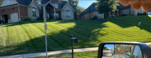 A freshly mowed lawn with distinct stripes in front of residential homes by Affordable Lawn Care llc in Bowling Green, KY.