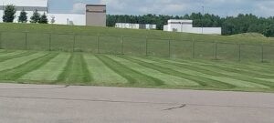 A freshly mowed lawn with distinct stripes, showcasing professional lawn care by Bullseye Lawn Care and Tree Service LLC in Sioux Falls, SD.