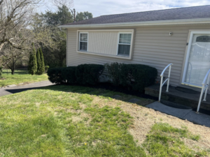 Freshly mulched flower beds and trimmed shrubs at a home by All Things Lawncare in Knoxville, TN.