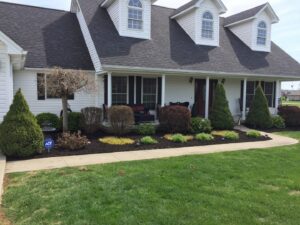 A front yard with freshly mulched flower beds and a well-maintained lawn by Ryan's Lawn Service, LLC in Charlotte, NC.