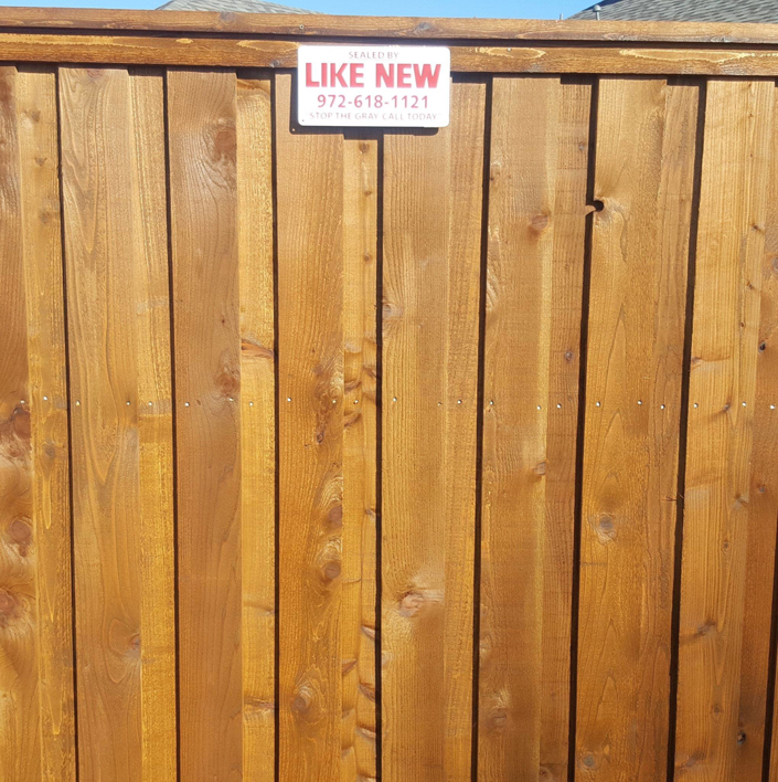 A freshly stained wooden fence completed by Like New Fence Staining & Restoration in Plano, TX