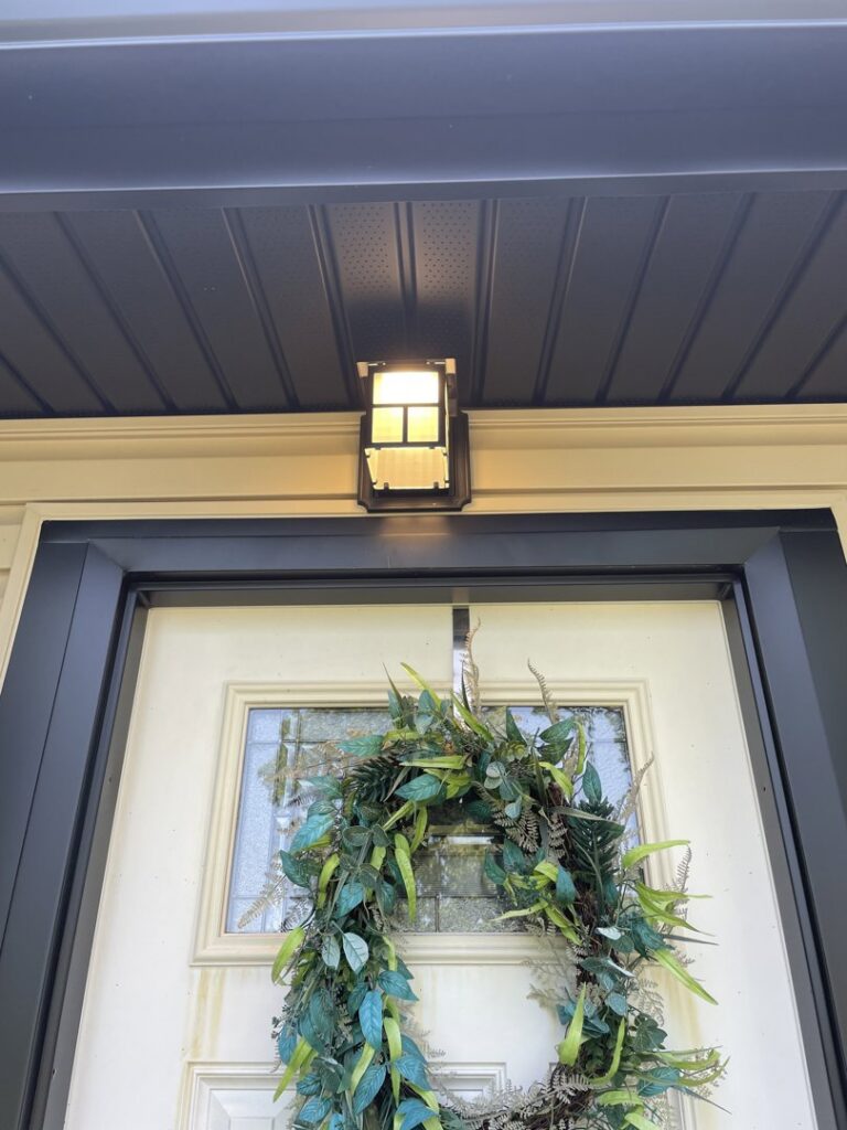 An exterior light fixture installed above a front door by GBE. Lectrical LLC in Gaithersburg, MD