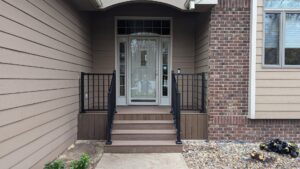 A front porch with newly installed black metal railings by Babb Custom Fence in Sioux Falls, SD.