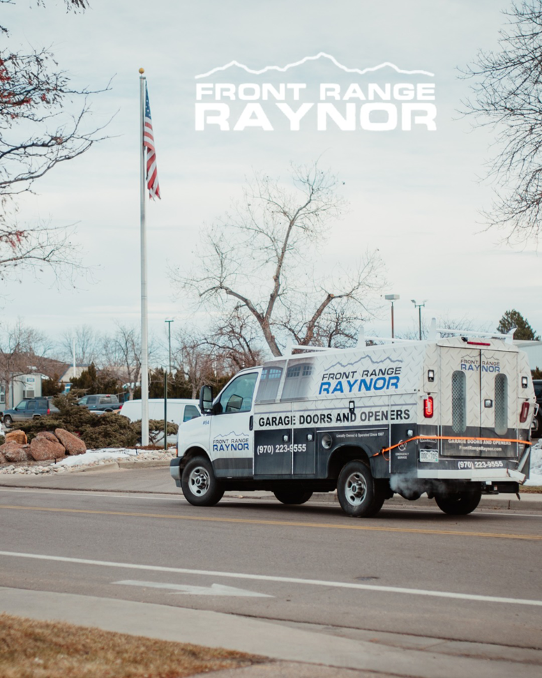 A Front Range Raynor Garage Door & Service van driving in Fort Collins, CO, ready for a garage door job.