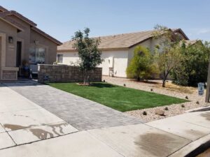 Front yard landscape featuring artificial turf and decorative pavers by AZ Hardscape & Landscape LLC in Phoenix, AZ.