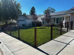 A stylish black metal fence installed around a residential front yard by Finest Fence in Simi Valley, CA.