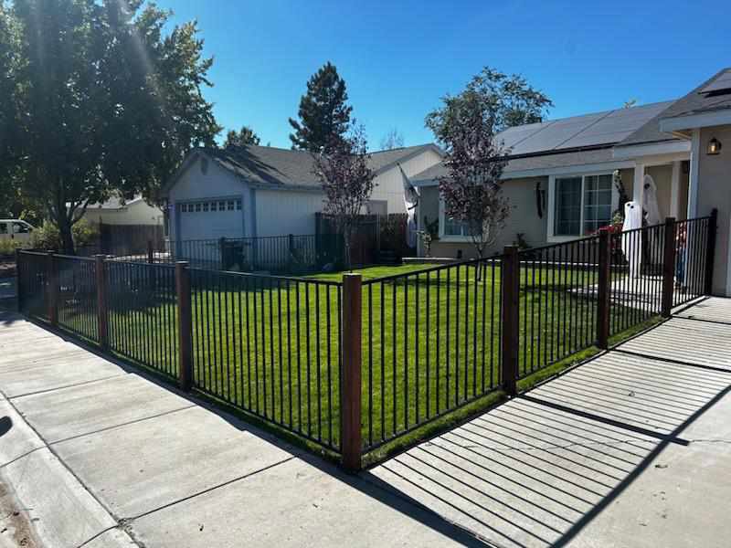 A stylish black metal fence installed around a residential front yard by Finest Fence in Simi Valley, CA.
