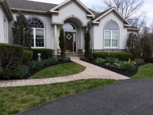 Front yard landscaping with fresh mulch and trimmed bushes by John's Lawn Care Service's in Saint Petersburg, FL