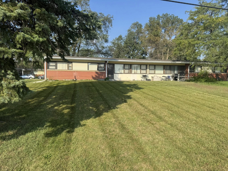 A well-maintained front yard with a freshly mowed lawn and clear stripes, provided by Bramble Clean Cut Lawn Care LLC in Independence, MO.