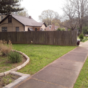 A front yard with neatly mowed grass and well-maintained landscaping by Christian Lawncare Services in Memphis, TN.