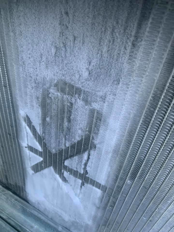 A heavily frosted HVAC coil indicating a system issue, serviced by Thomas HVAC LLC in Huntsville, AL