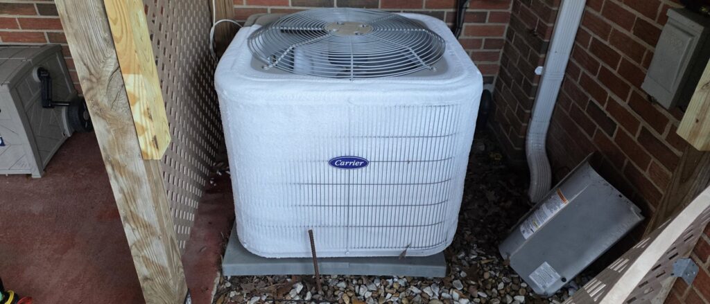 A frozen outdoor AC condenser unit requiring service from By the Bay Mechanical in Prince Frederick, MD