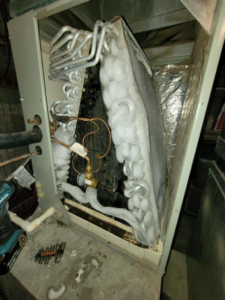 A severely frozen air conditioning evaporator coil requiring repair by Glacier Air Conditioning & Refrigeration Ltd. in Chilliwack, BC.