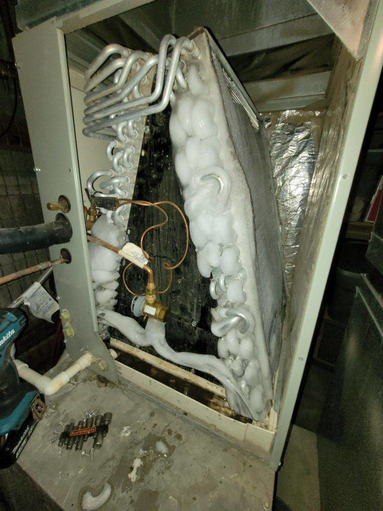 A severely frozen air conditioning evaporator coil requiring repair by Glacier Air Conditioning & Refrigeration Ltd. in Chilliwack, BC.