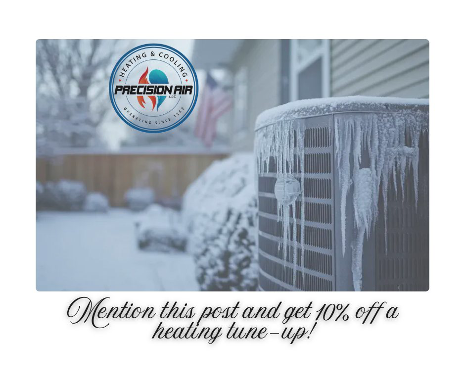 A frozen outdoor AC unit covered in snow and icicles during winter, representing services by Precision Air in Vancouver, WA.