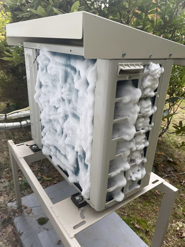 A frozen outdoor HVAC unit requiring service, demonstrating repair work by Laird's HVAC in Auburn, ME.