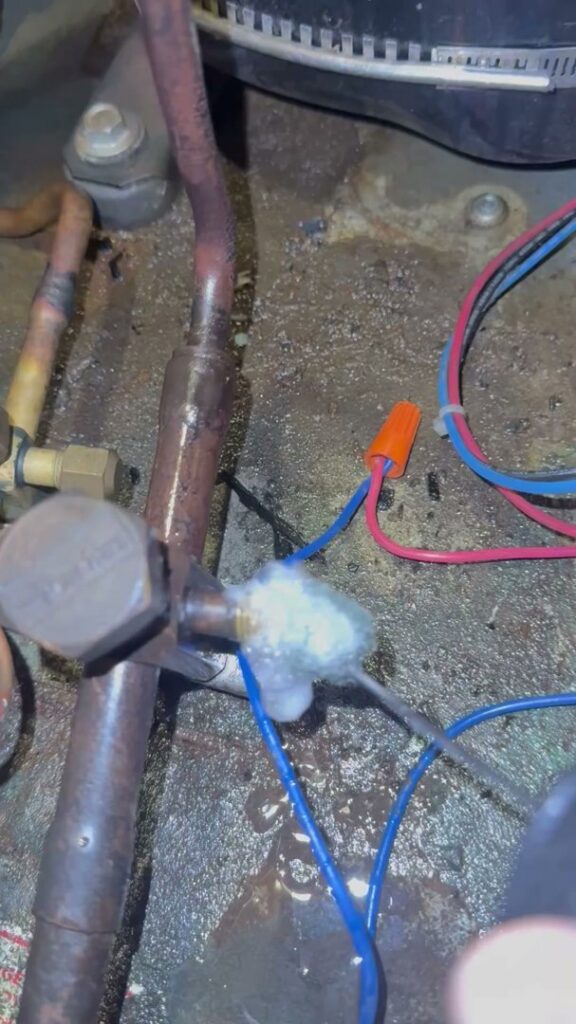 A frozen refrigerant line on an HVAC unit, indicating a problem being addressed by OnPoint Heating and Air in Commerce City, CO.