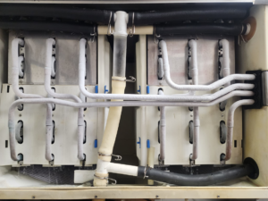 Close-up of frozen refrigeration coils and pipes indicating a service issue, addressed by Facility Doctors in Raleigh, NC