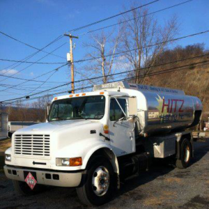 A white fuel oil delivery truck for Hitz Heating Inc. providing heating and AC service in Harrisburg, PA.