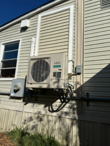 A Fujitsu Airstage mini-split outdoor unit professionally installed on a building by R&R Climate Systems in Newark, NJ