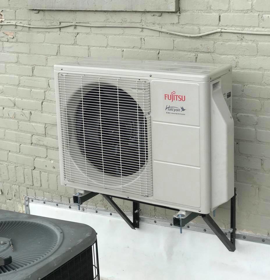 A Fujitsu Halcyon mini-split outdoor unit mounted on a brick wall, installed by Eastern Air Flow of Kentucky in Richmond, KY.
