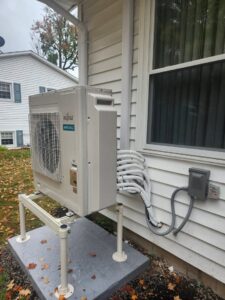 An outdoor Fujitsu mini-split condenser unit mounted on a stand, installed by Allied Heating and Air Conditioning in Port Richey, FL.