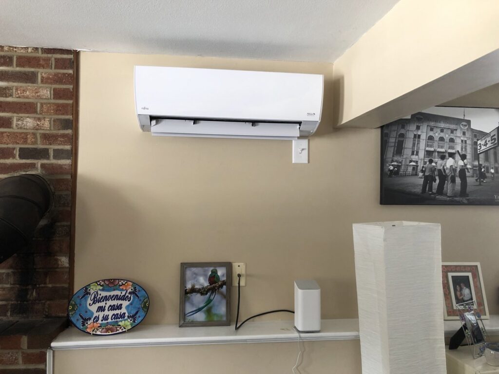 An indoor Fujitsu mini-split air conditioning unit installed on a wall in a home by Garrison City HVACR in Dover, NH