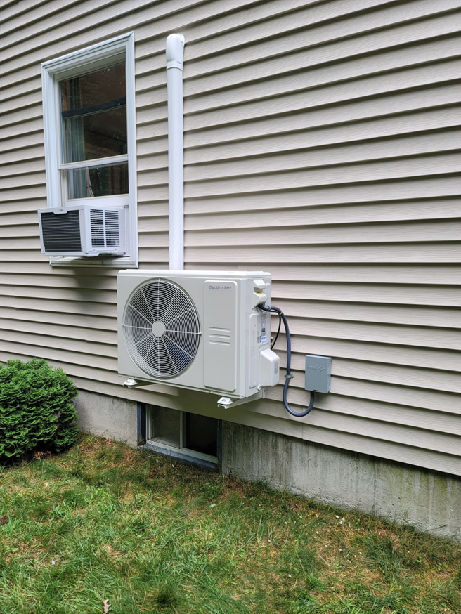 A Fujitsu mini-split outdoor condenser unit installed on a home's exterior by Mini Split Solutions in Austin, TX