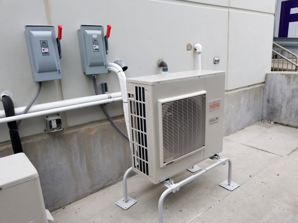 An outdoor Fujitsu mini-split condenser unit installed by Debbie's Heating and Cooling in South Bend, IN.