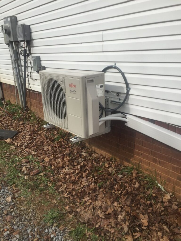 A Fujitsu mini-split outdoor unit professionally installed on a home by Johnson's Heating and Cooling in Clarksville, TN.