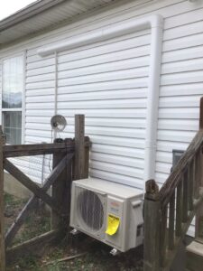 A Fujitsu mini-split outdoor unit installed on the side of a home by Wright Heating and Air in Louisville, KY.