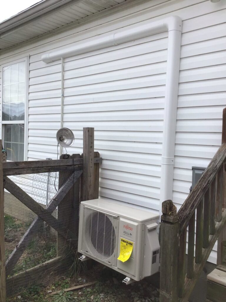 A Fujitsu mini-split outdoor unit installed on the side of a home by Wright Heating and Air in Louisville, KY.
