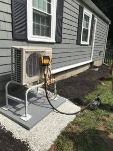 A Fujitsu mini-split outdoor unit being serviced or installed by EML Mechanical in Boston, MA.
