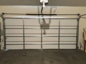 A full interior view of a white garage door showing panels and tracks, installed by 4 Sons Garage Door in Phoenix, AZ.