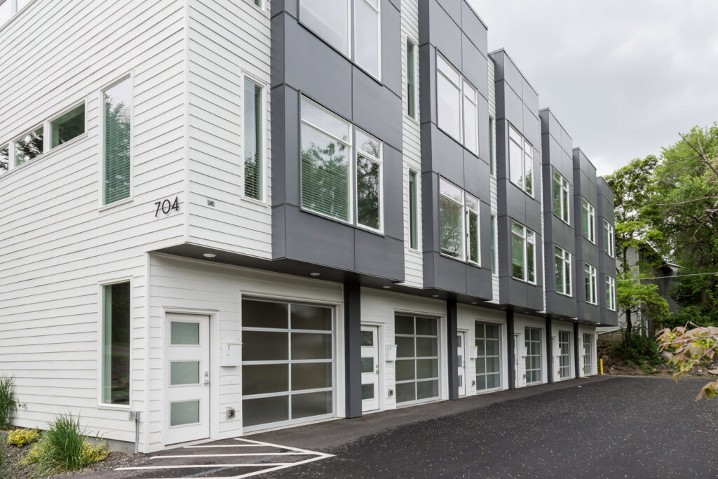 Full-view glass garage doors on a row of modern townhouses, installed by Continental Door Company in Spokane Valley, WA.