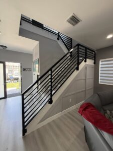 A full view of a modern black metal stair railing installed by Osuna Ornamental Fences & Gates in Cutler Bay, FL.