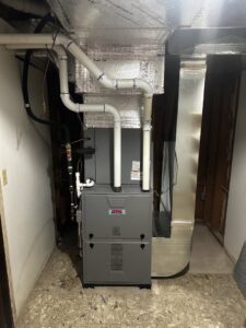 A furnace and air handler unit with new ductwork and PVC piping installed by Alpine Pro Solutions in Allentown, PA.