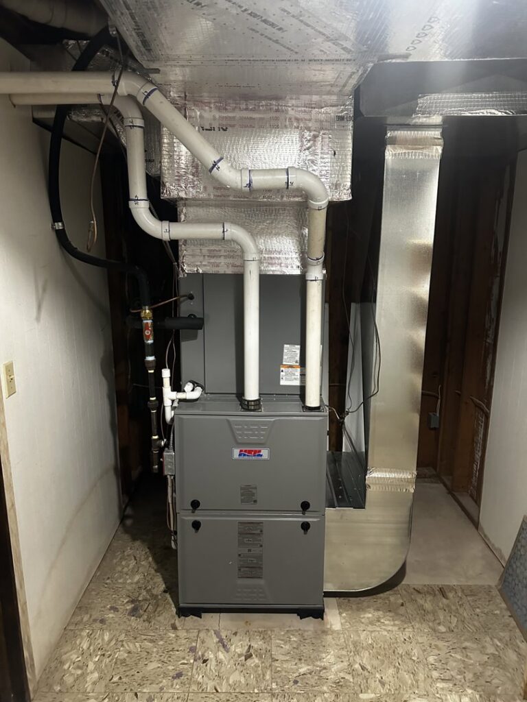 A furnace and air handler unit with new ductwork and PVC piping installed by Alpine Pro Solutions in Allentown, PA.