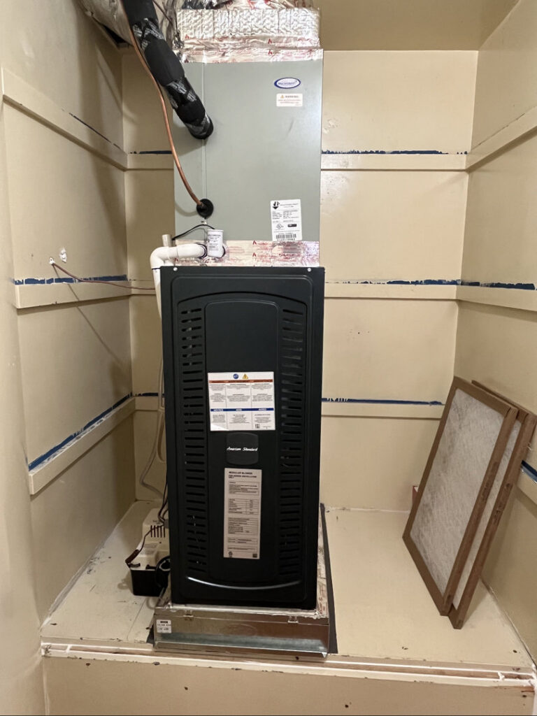 A furnace and air handler unit installed in a utility closet by 20th Century Heating and Air in Anaheim, CA.